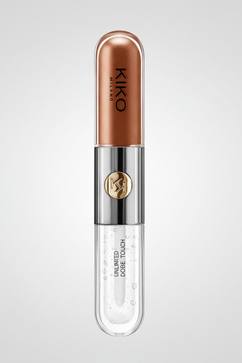 Kiko Milano Unlimited Double Tough lip gloss in a clear tube showing a coppery rose-brown gloss inside, with a metallic silver cap and a gold circular logo.